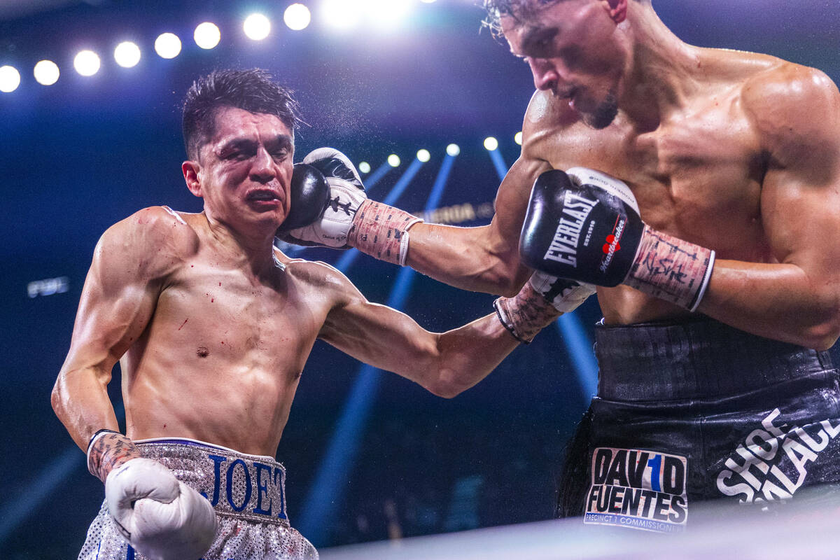 Joet Gonzalez takes a punch to the head from Brandon Figueroa during their WBA featherweight ti ...
