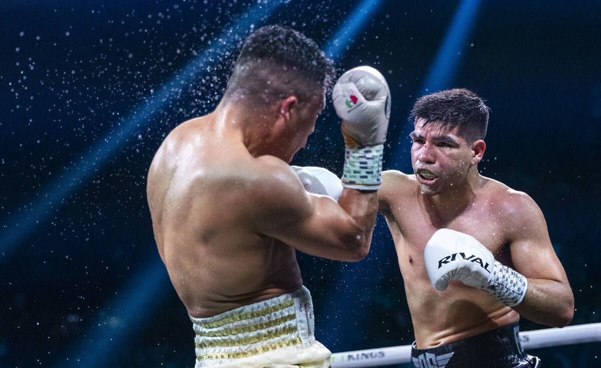 Isaac Cruz takes a shot to the face from Omar Salcido during their interim WBC super lightweigh ...