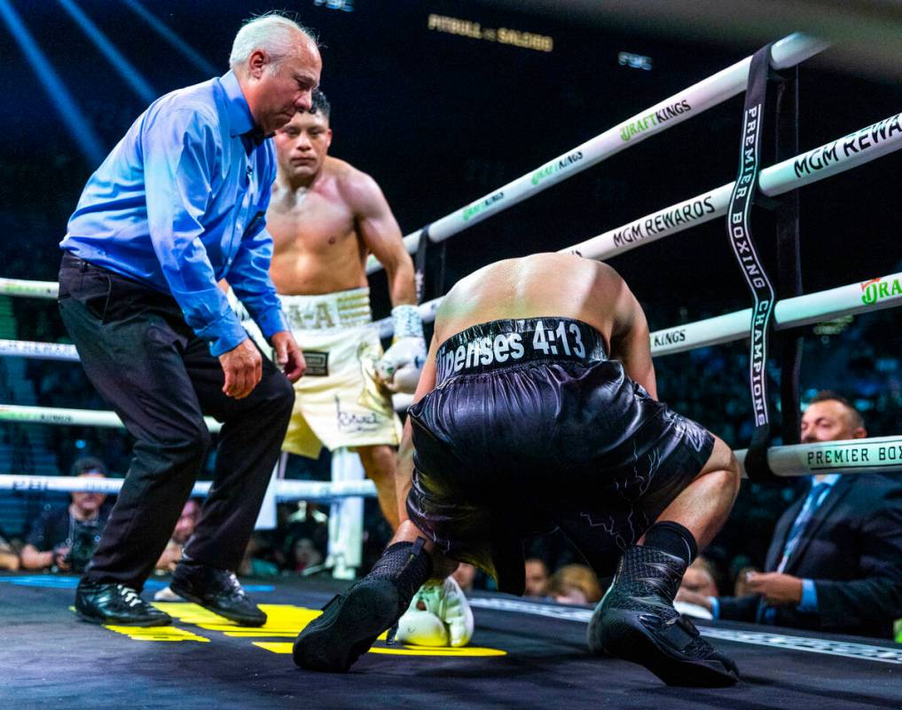 Isaac Cruz looks to Omar Salcido doubled over in the corner during their interim WBC super ligh ...