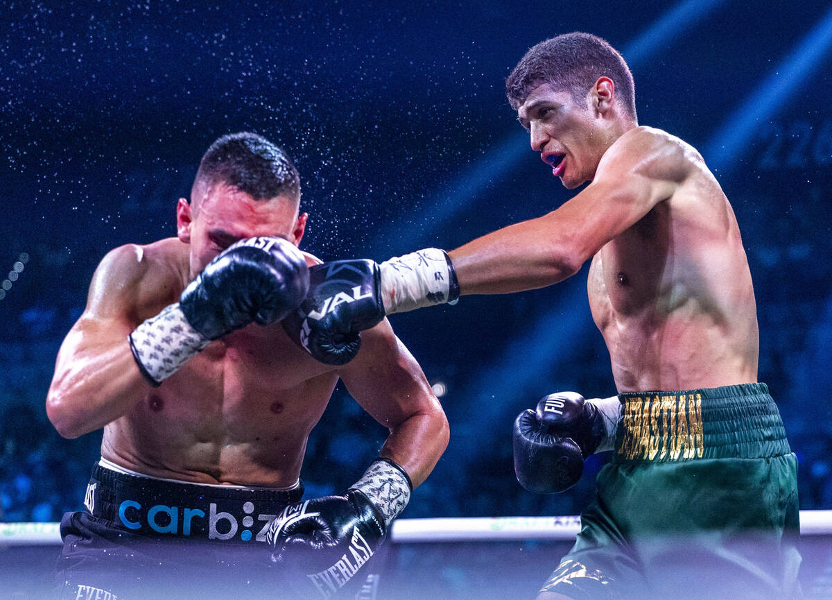 Tim Tszyutakes a shot to the face from Sebastian Fundora during their WBC super welterweight ch ...