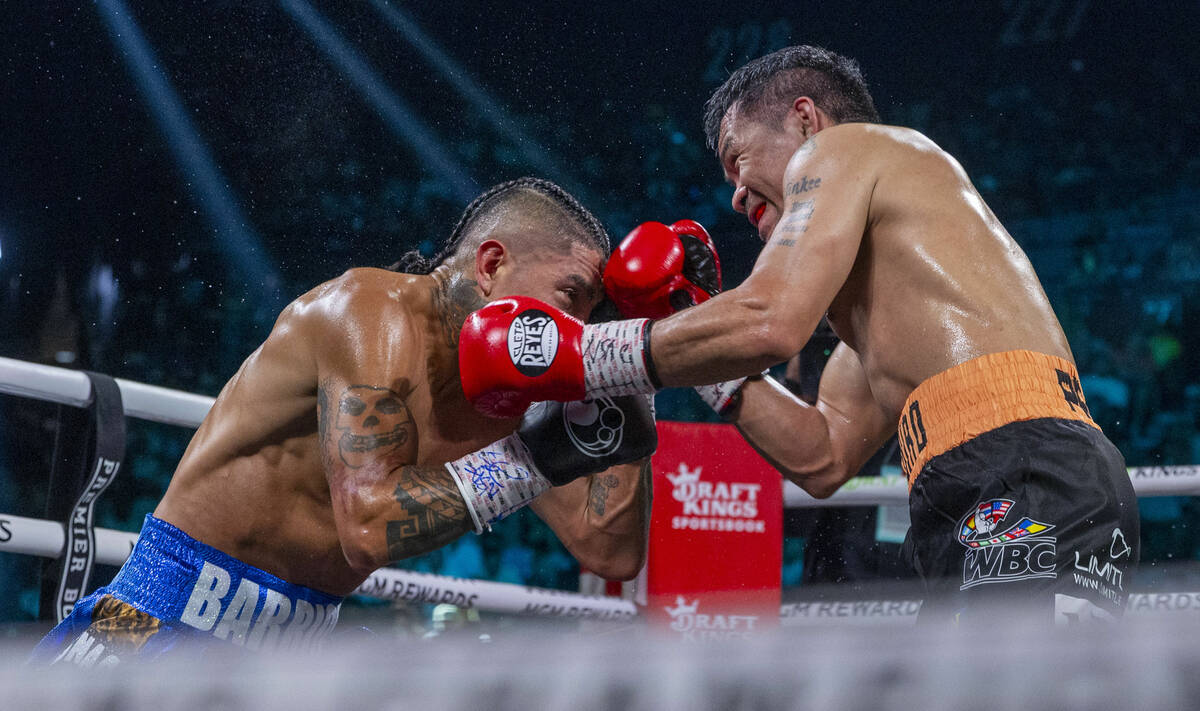 Mario Barrios and Manny Pacquiao trade punches during their WBC welterweight championship fight ...