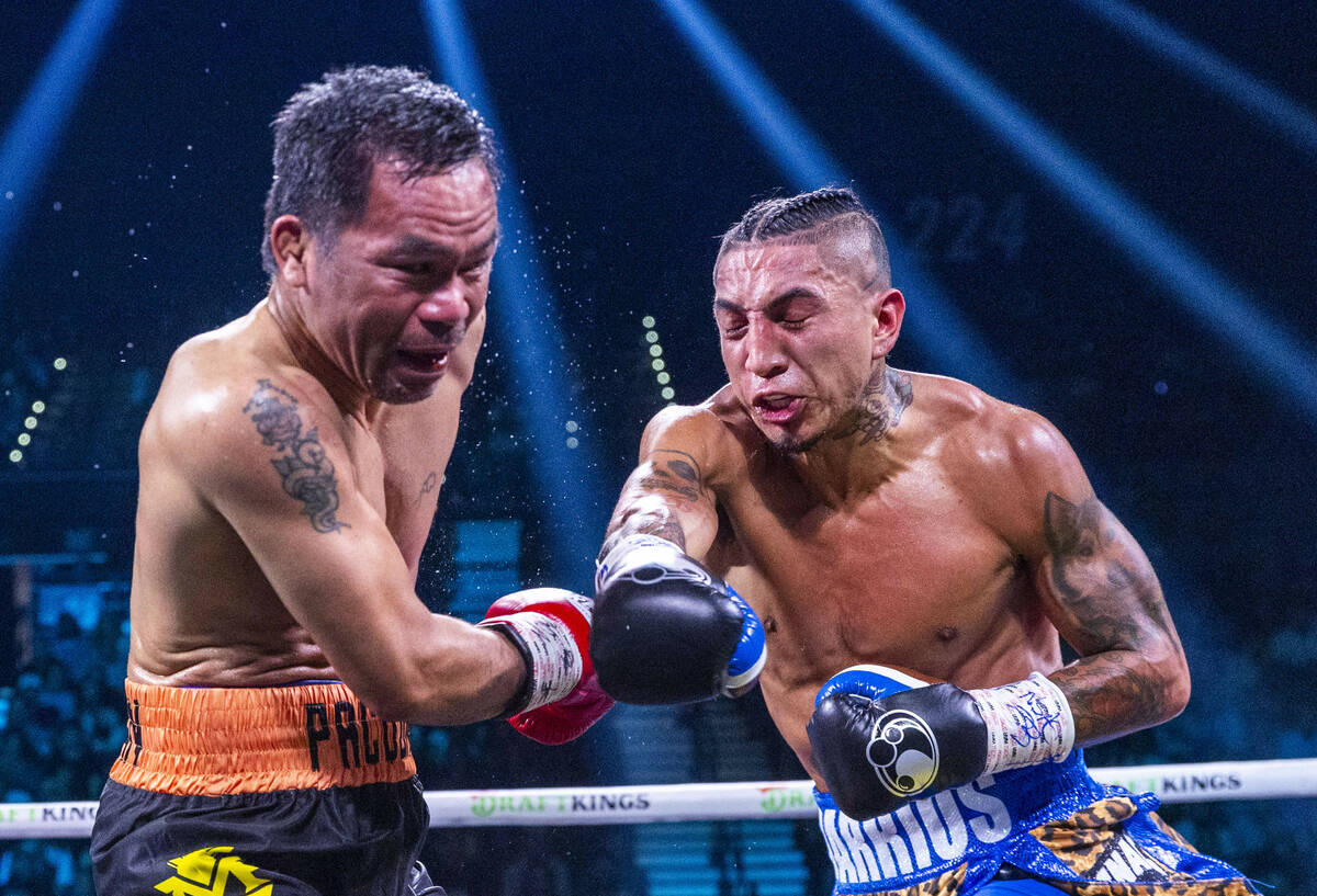 Manny Pacquiao takes a big hit from Mario Barrios during their WBC welterweight championship fi ...