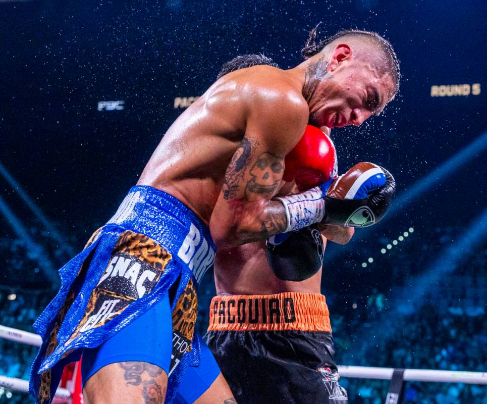 Mario Barrios absorbs an uppercut from Manny Pacquiao during their WBC welterweight championshi ...
