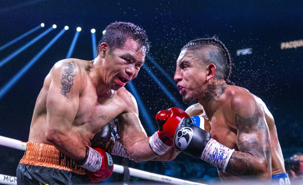Manny Pacquiao and Mario Barrios trade punches during their WBC welterweight championship fight ...