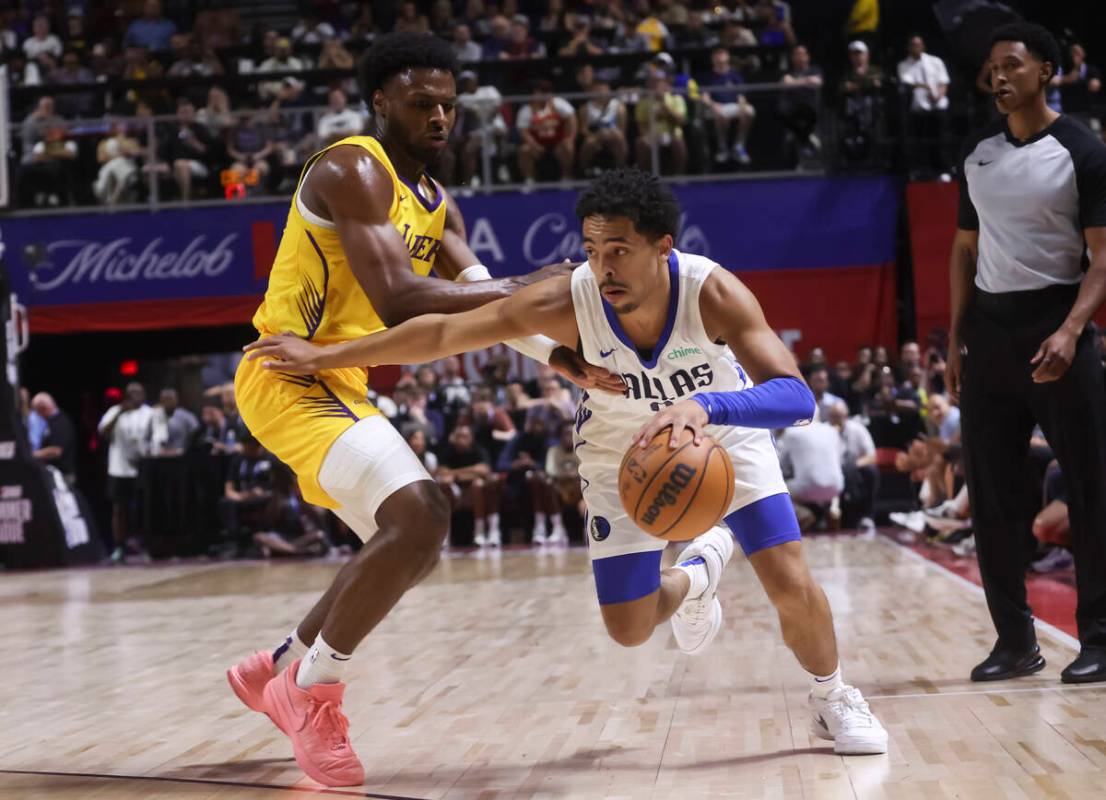 Dallas Mavericks guard Ryan Nembhard, right, drives the ball against Los Angeles Lakers guard B ...
