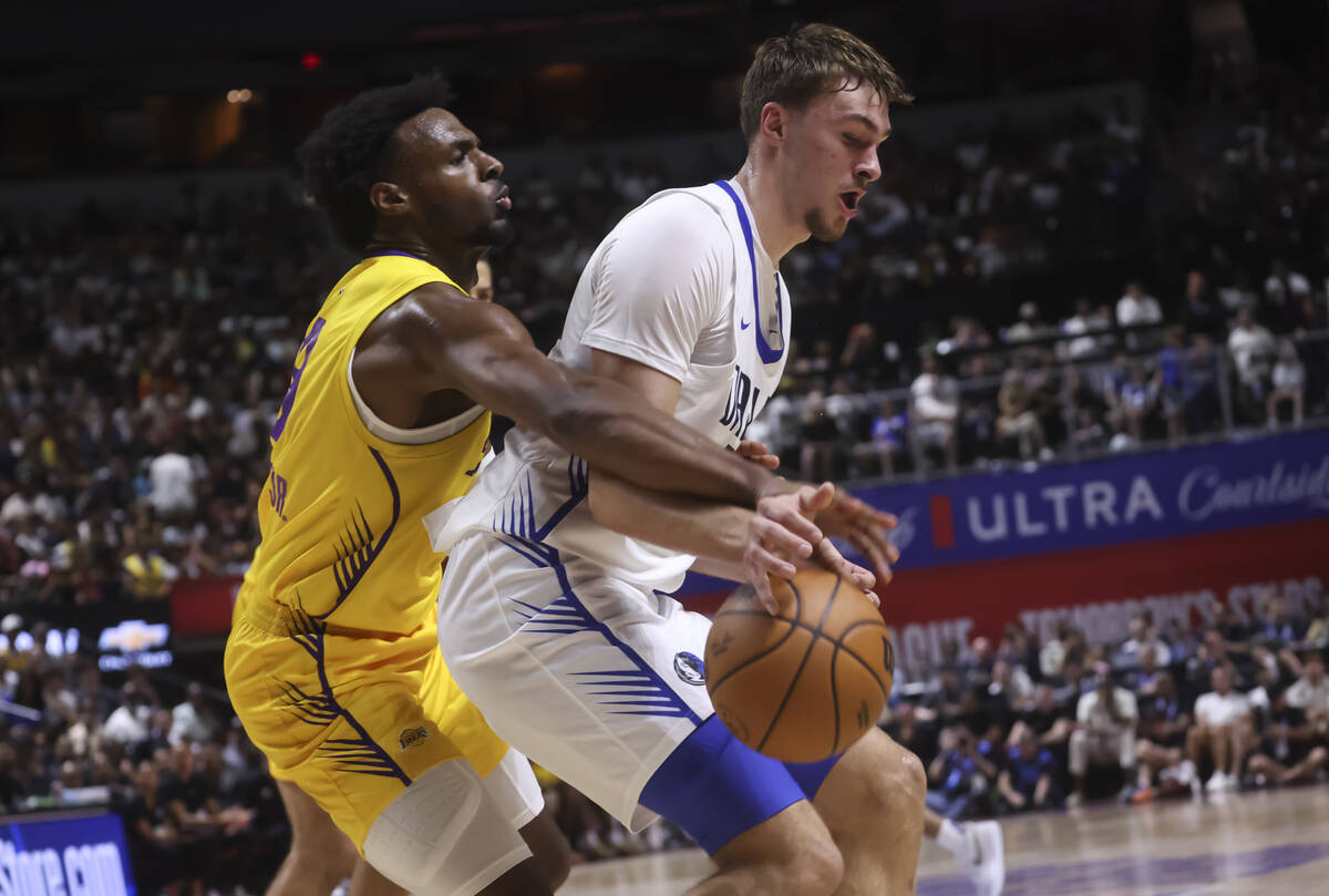 Los Angeles Lakers guard Bronny James, left, defends against Dallas Mavericks Cooper Flagg (32) ...