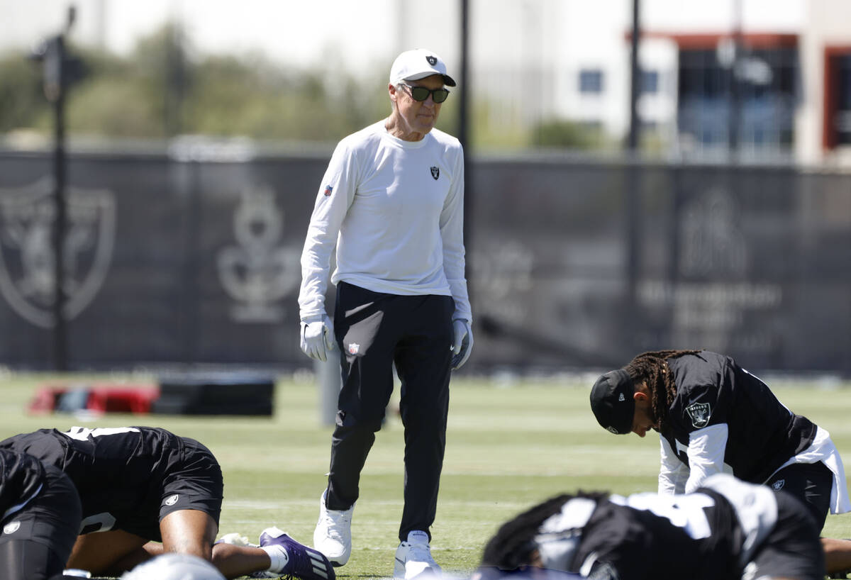 Raiders head coach Pete Carroll watches as players stretch during the 2025 rookie mini camp at ...