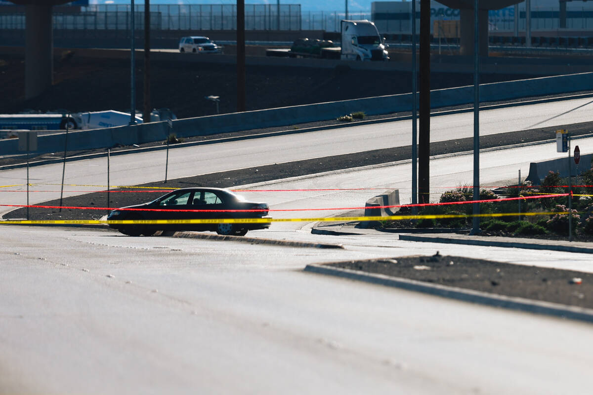 A car is left on a median as North Las Vegas police investigate an officer involved shooting at ...