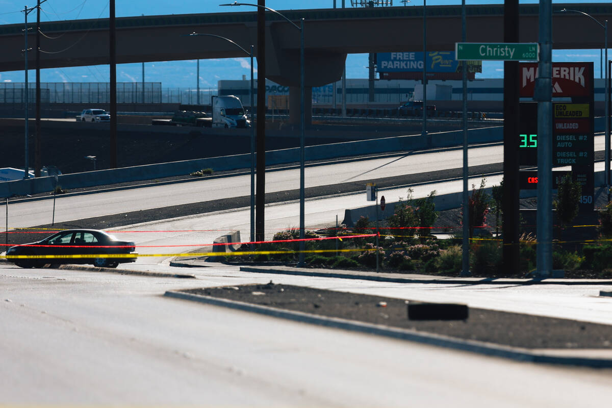 A car is left on a median as North Las Vegas police investigate an officer involved shooting at ...