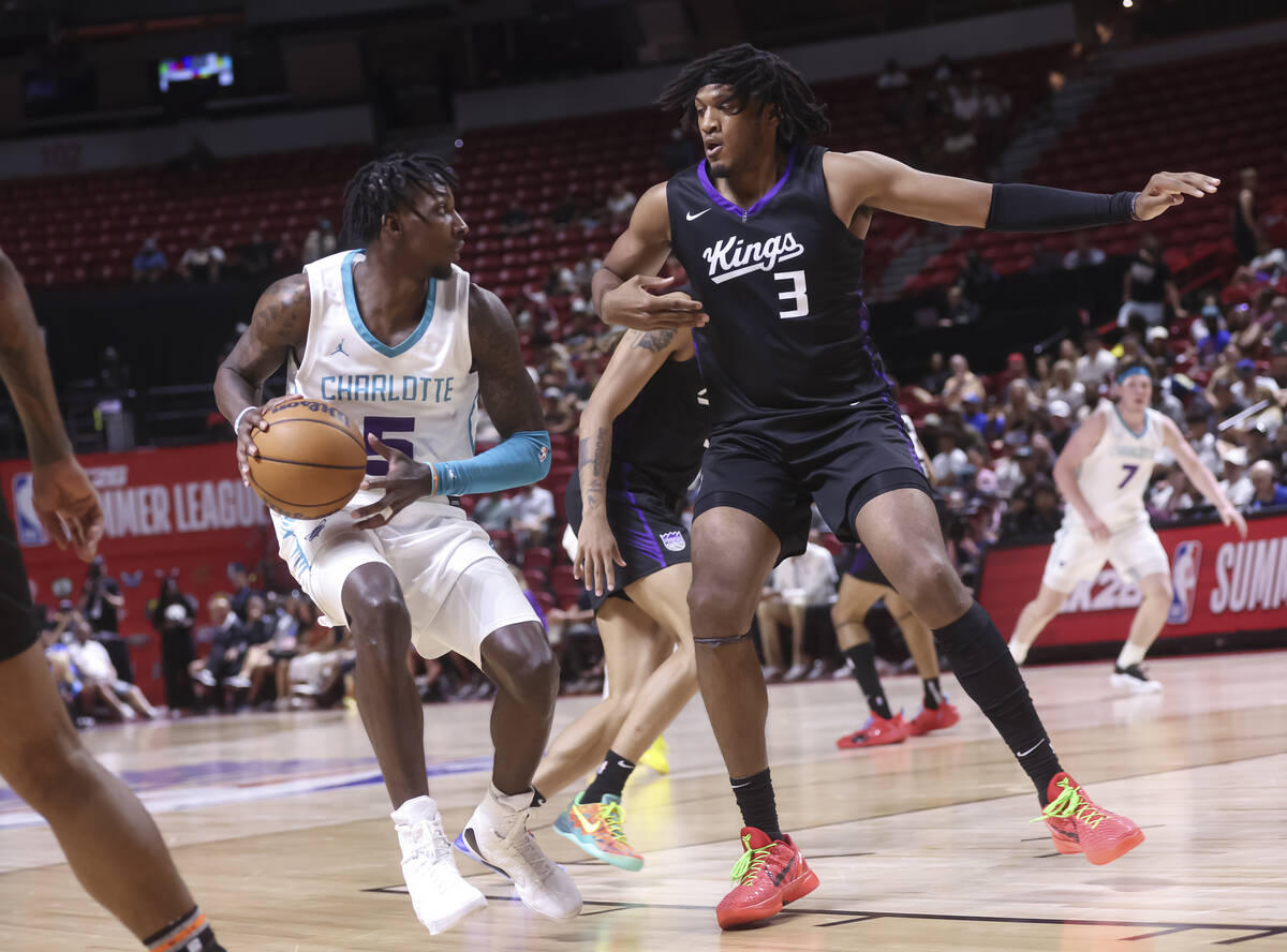 Charlotte Hornets guard Damion Baugh (5) looks to shoot around Sacramento Kings forward Isaac J ...