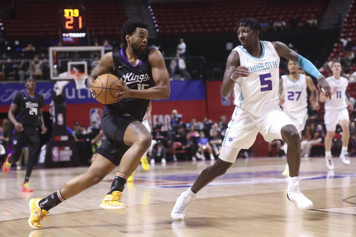 Sacramento Kings guard Mason Jones (15) brings the ball up court against Charlotte Hornets guar ...