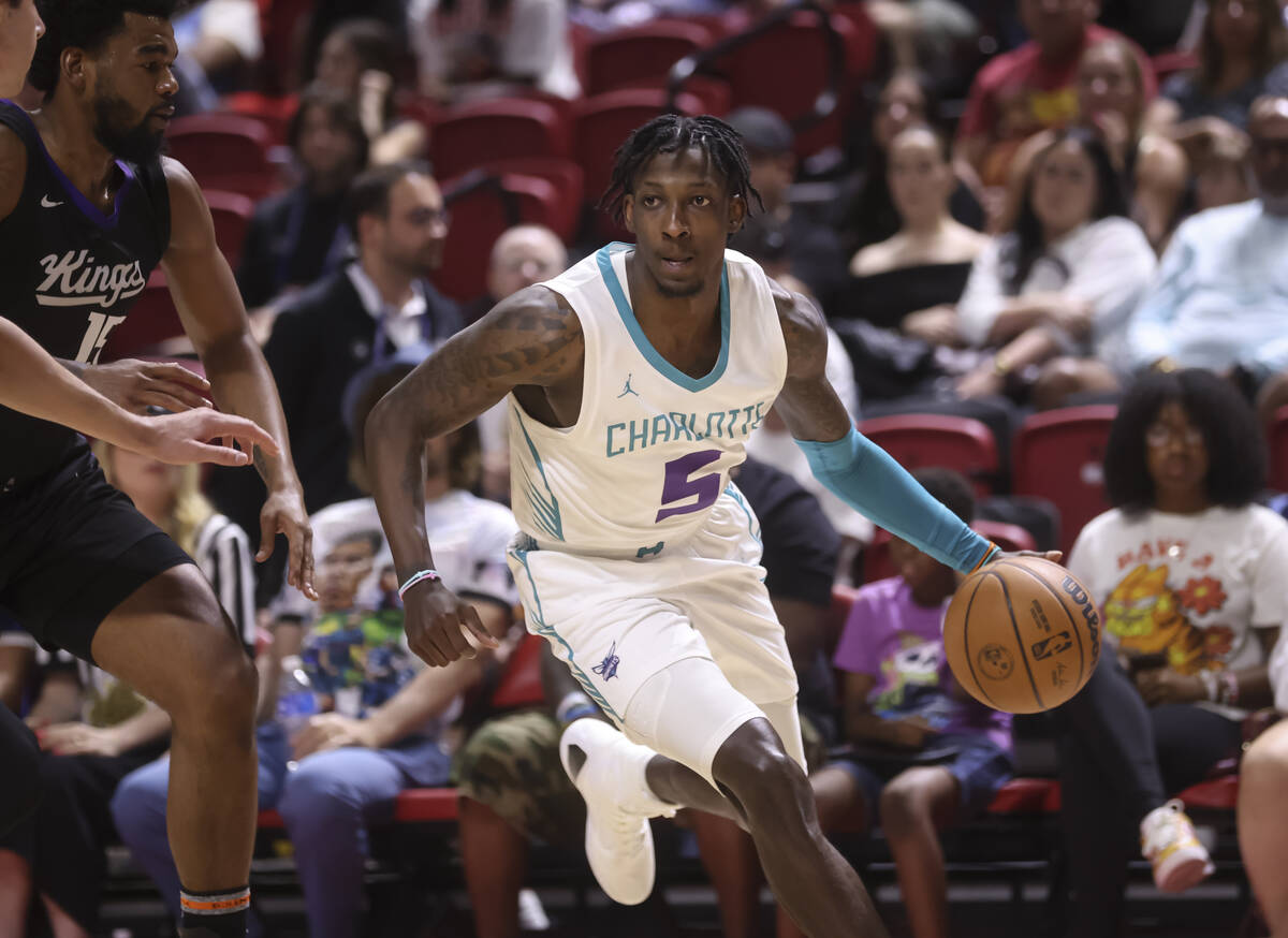 Charlotte Hornets guard Damion Baugh (5) drives around Sacramento Kings guard Mason Jones (15) ...
