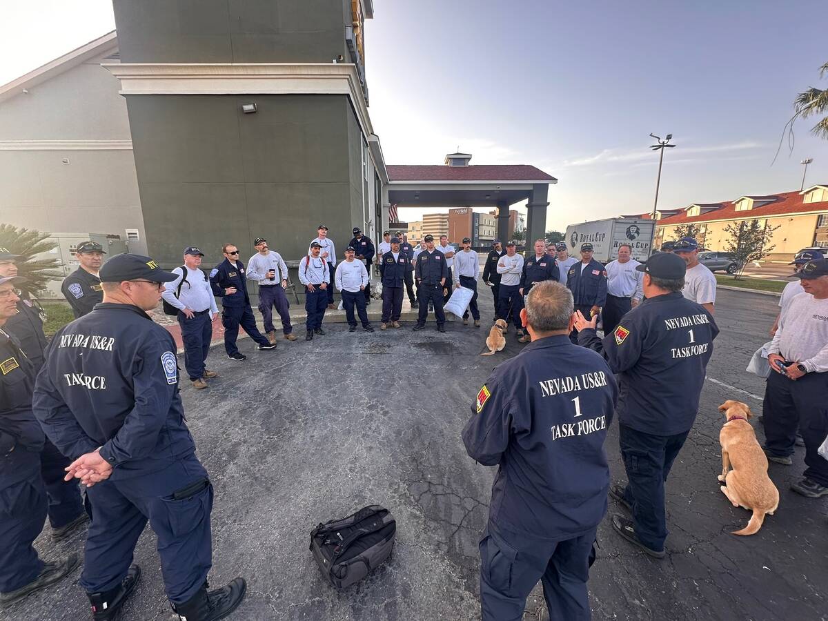 In this undated photo, members of Nevada Task Force-1 discuss their response to floods on July ...