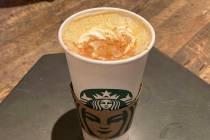 A Pumpkin Spice Latte drink rests on a table at a Starbucks in New York, on Thursday, Aug. 24, ...