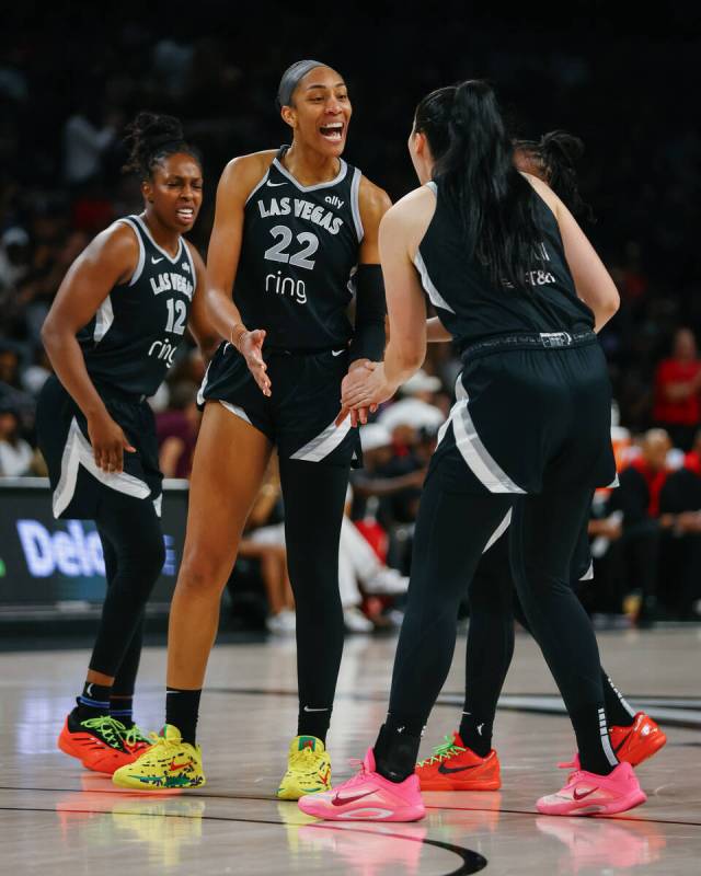Las Vegas Aces center A'ja Wilson (22) celebrates with teammate Las Vegas Aces center Megan Gus ...