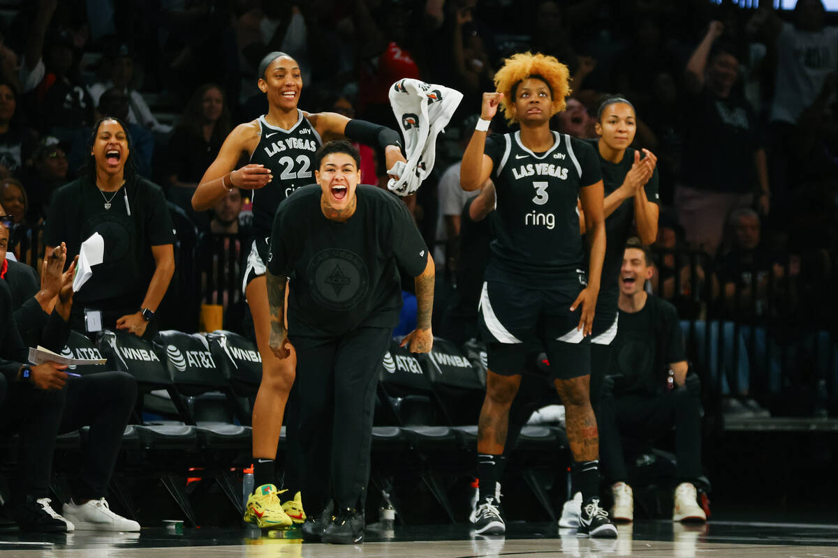 The Las Vegas Aces bench erupts as they gain momentum in the second half of a game between the ...