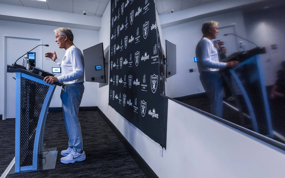 Raiders head coach Pete Carroll is reflected in a large video screen as he speaks during a pres ...