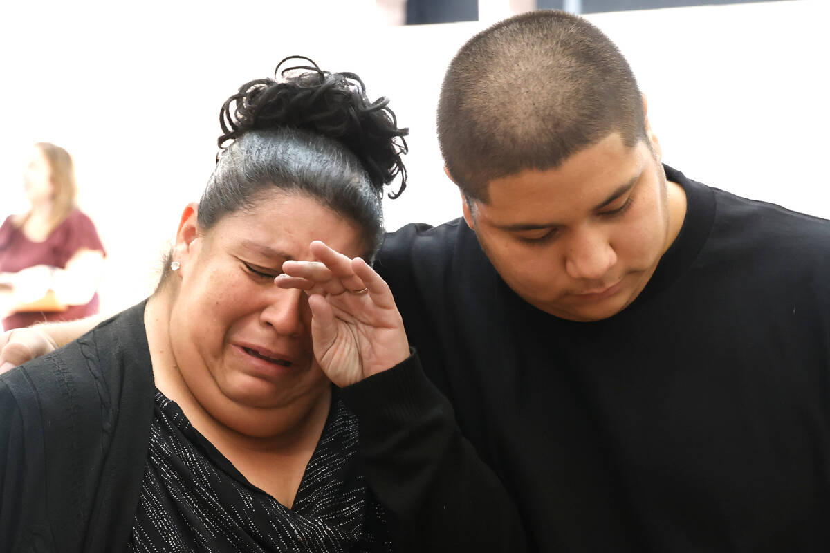 Candida Ureño, the daughter of Ricardo Ureño, is comforted by her son Daniel as she weeps dur ...