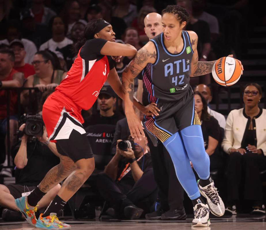 Atlanta Dream center Brittney Griner (42) moves the ball around Aces forward NaLyssa Smith (3) ...