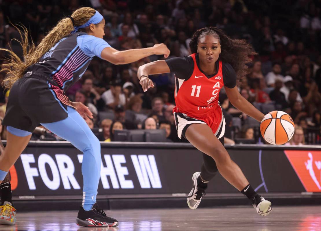Aces guard Dana Evans (11) drives to the basket under pressure from Atlanta Dream guard Jordin ...