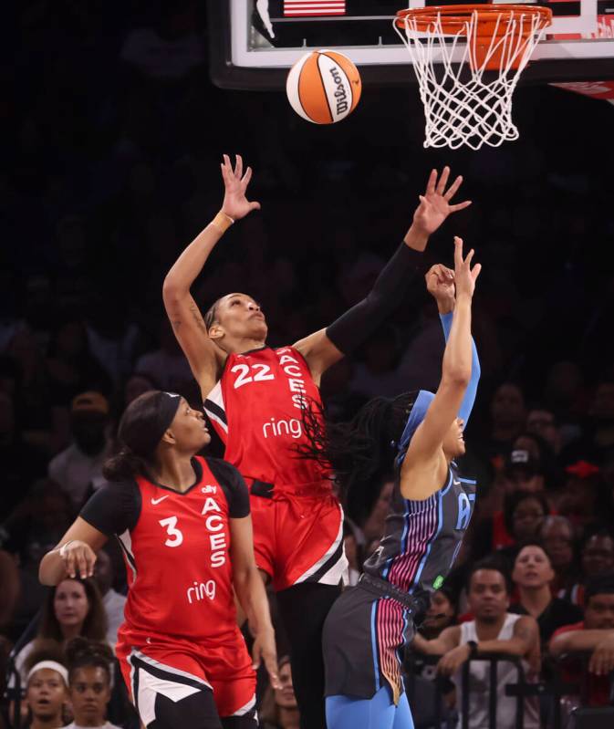 Aces center A'ja Wilson (22) reaches for the ball as Atlanta Dream guard Allisha Gray, right, l ...