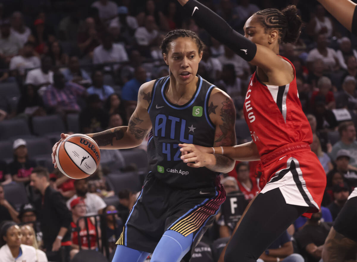 Atlanta Dream center Brittney Griner (42) drives the ball against Aces center A'ja Wilson (22) ...