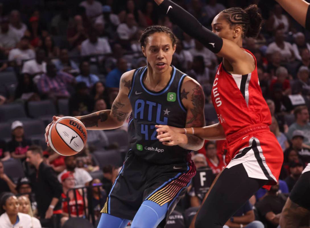 Atlanta Dream center Brittney Griner (42) drives the ball against Aces center A'ja Wilson (22) ...