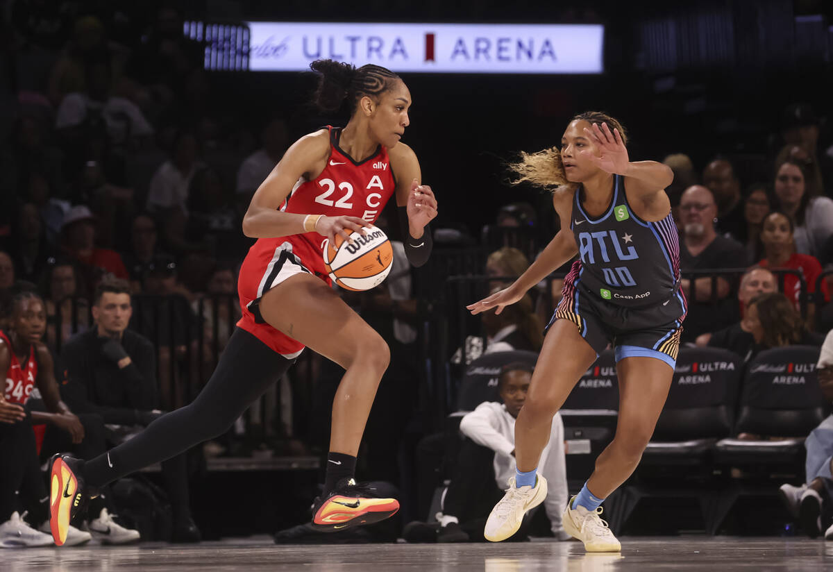 Aces center A'ja Wilson (22) drives to the basket against Atlanta Dream forward Naz Hillmon (0) ...