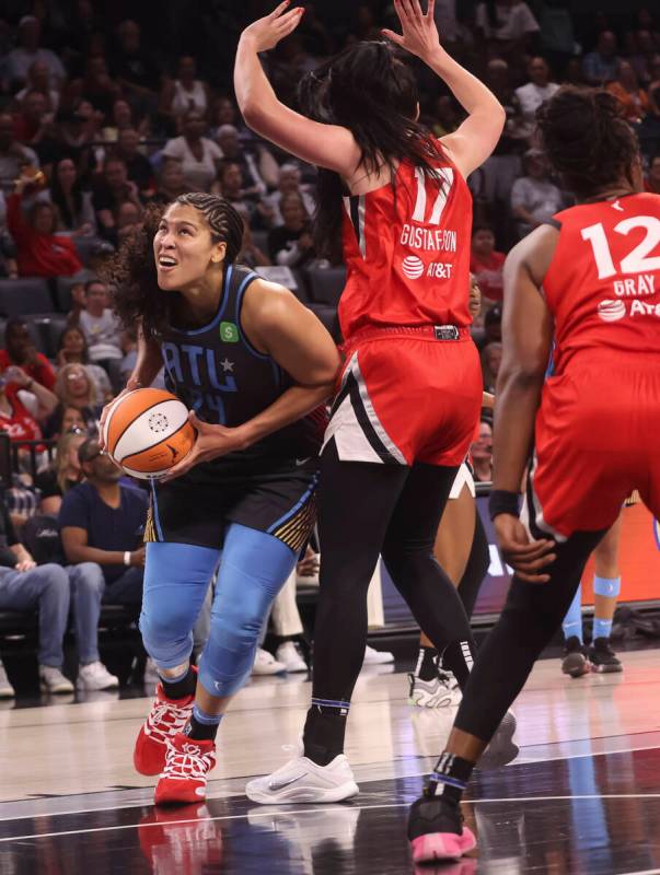 Atlanta Dream forward Brionna Jones (24) drives to the basket against Aces center Megan Gustafs ...