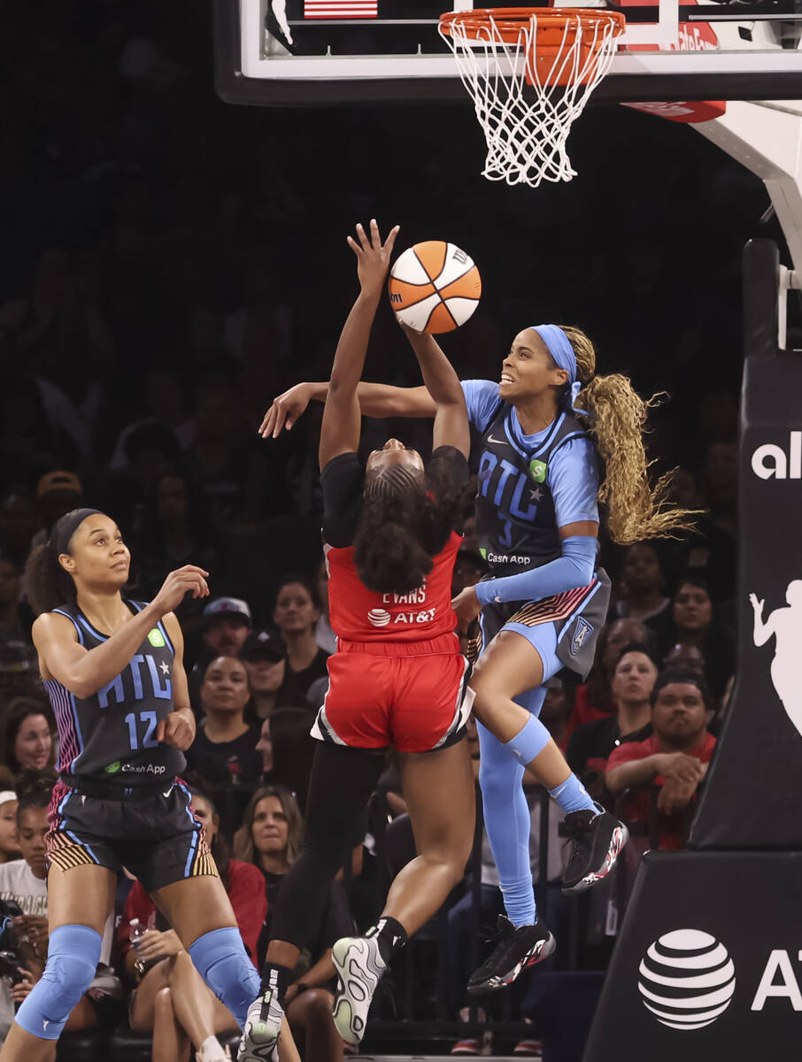 Aces guard Dana Evans (11) gets fouled by Atlanta Dream guard Jordin Canada (3) during the seco ...