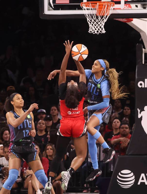 Aces guard Dana Evans (11) gets fouled by Atlanta Dream guard Jordin Canada (3) during the seco ...