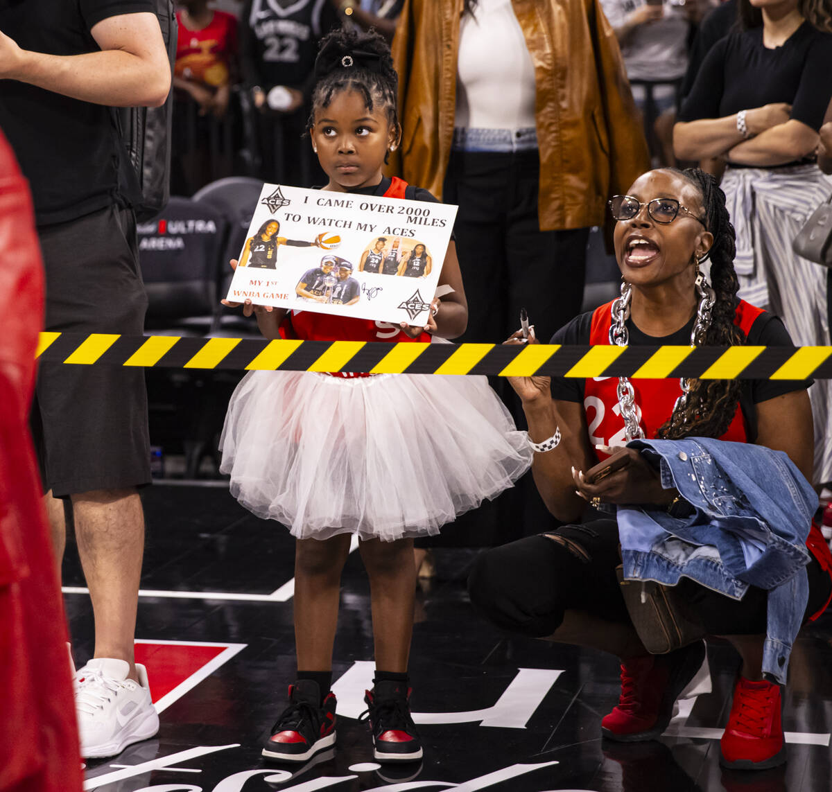 A young fan looks to the court after the Aces defeated the Atlanta Dream in a WNBA basketball g ...