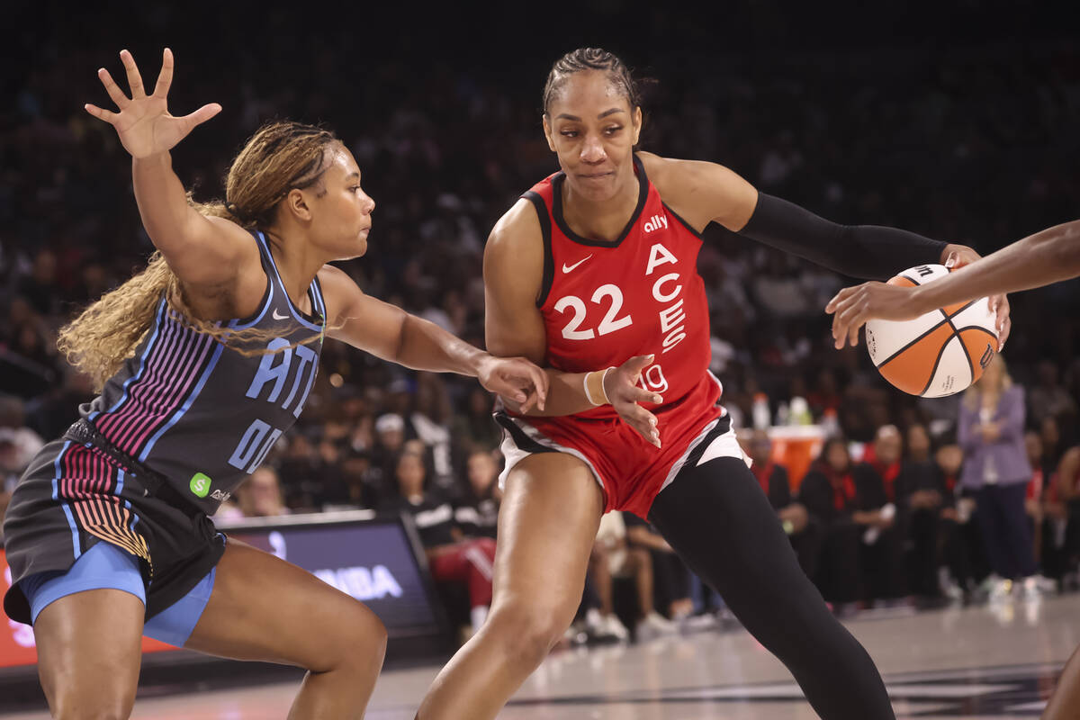Aces center A'ja Wilson (22) drives the ball as Atlanta Dream forward Naz Hillmon (0) defends d ...