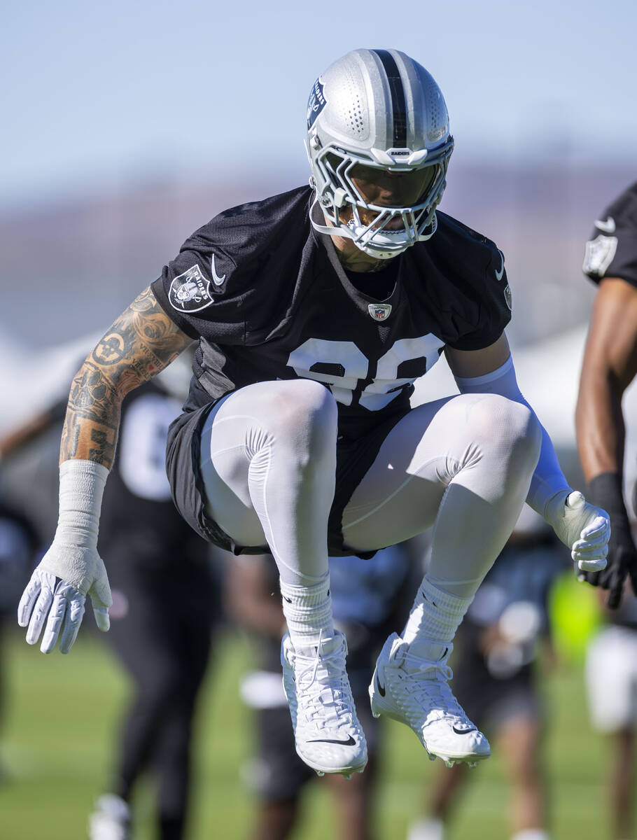 Raiders defensive end Maxx Crosby (98) warms up with teammates during the first day of training ...
