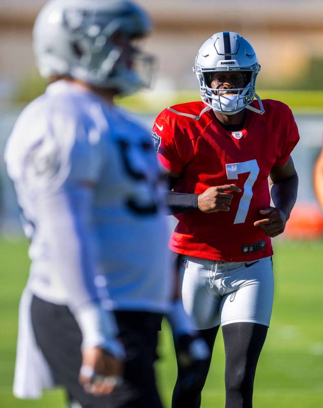 Raiders quarterback Geno Smith (7) warms up with teammates during the first day of training cam ...