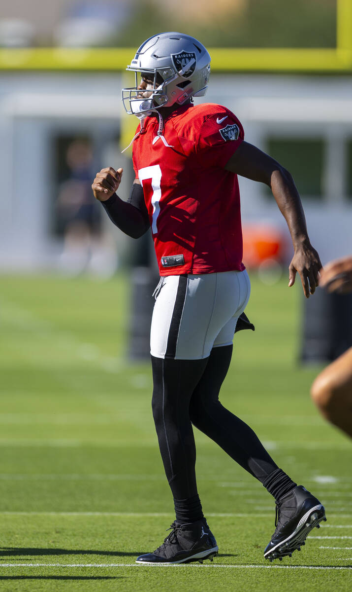 Raiders quarterback Geno Smith (7) warms up with teammates during the first day of training cam ...