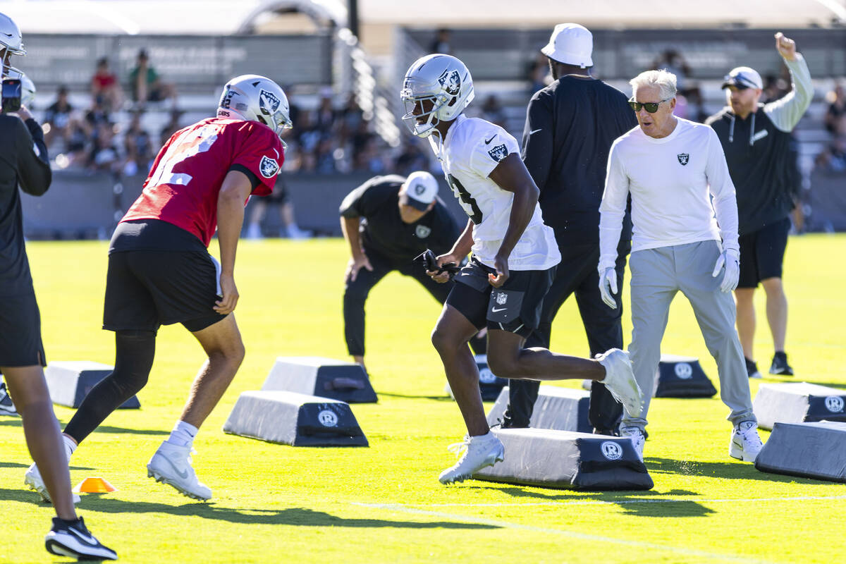 Raiders head coach Pete Carroll encourages his players as they run a drill during the first day ...