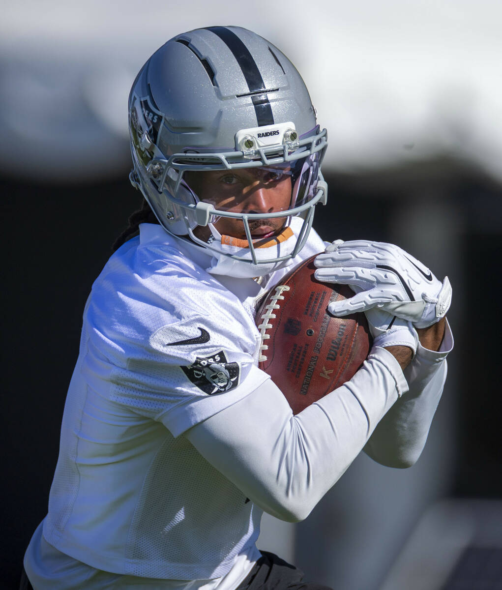 Raiders wide receiver Tre Tucker (1) catches a punt watches a drill during the first day of tra ...