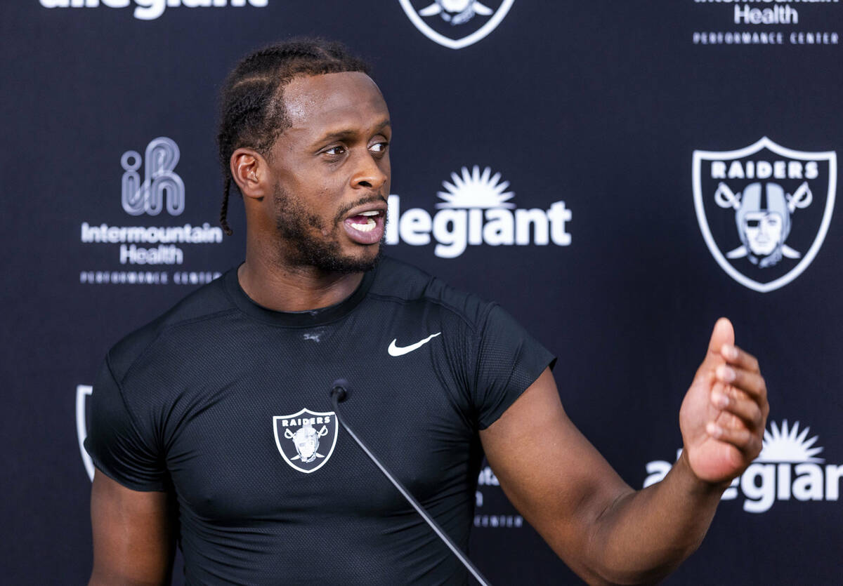 Raiders quarterback Geno Smith (7) speaks during an interview on the first day of training camp ...