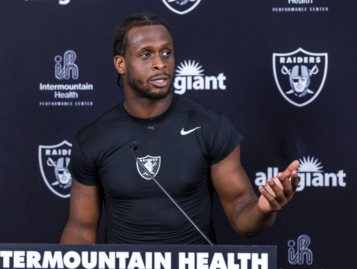 Raiders quarterback Geno Smith (7) speaks during an interview on the first day of training camp ...