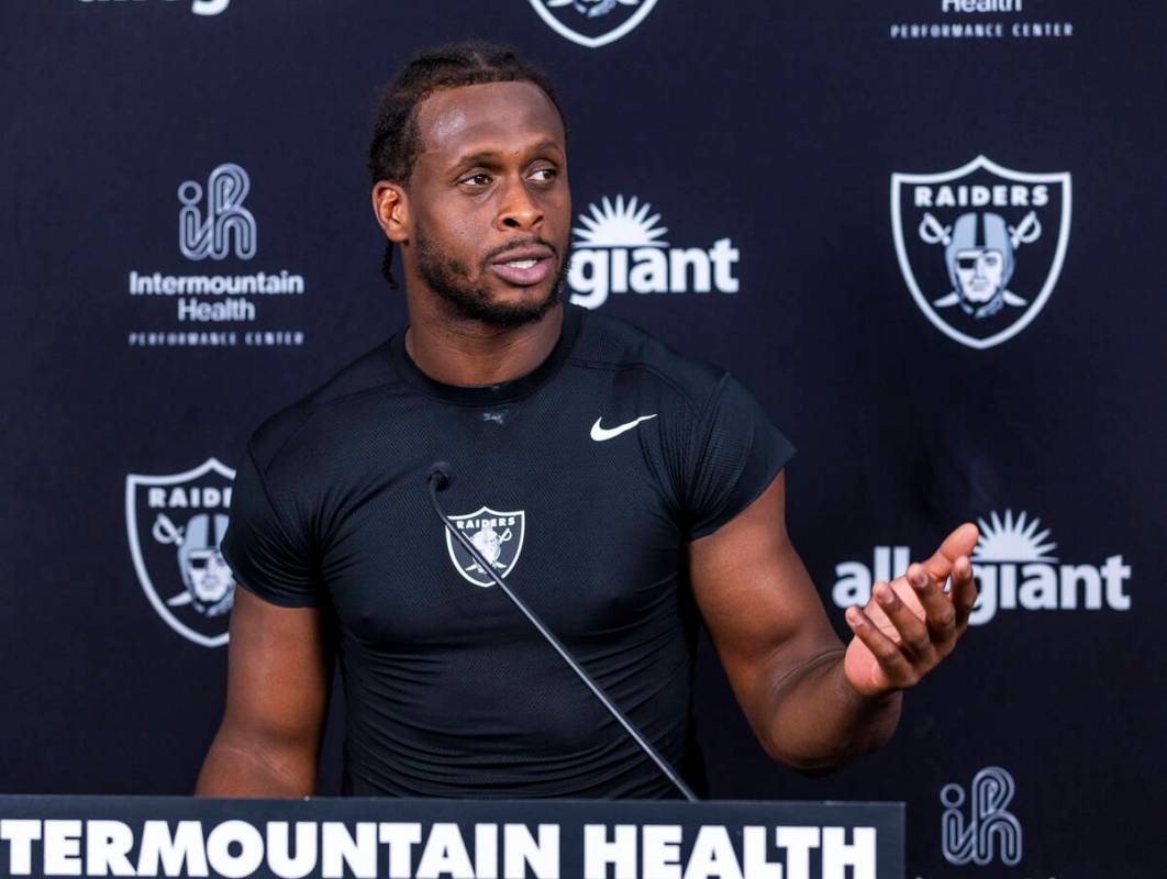 Raiders quarterback Geno Smith (7) speaks during an interview on the first day of training camp ...