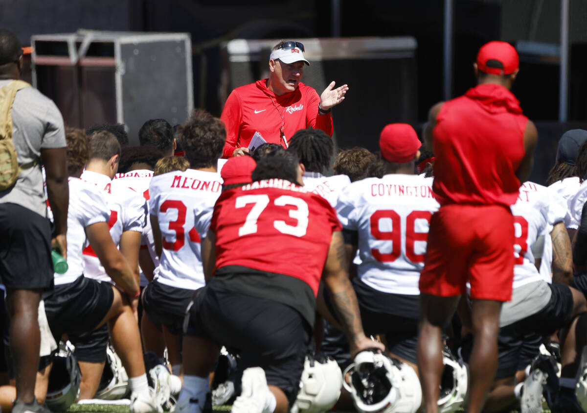 UNLV football head coach Dan Mullen talks to his players after the first day of football camp a ...