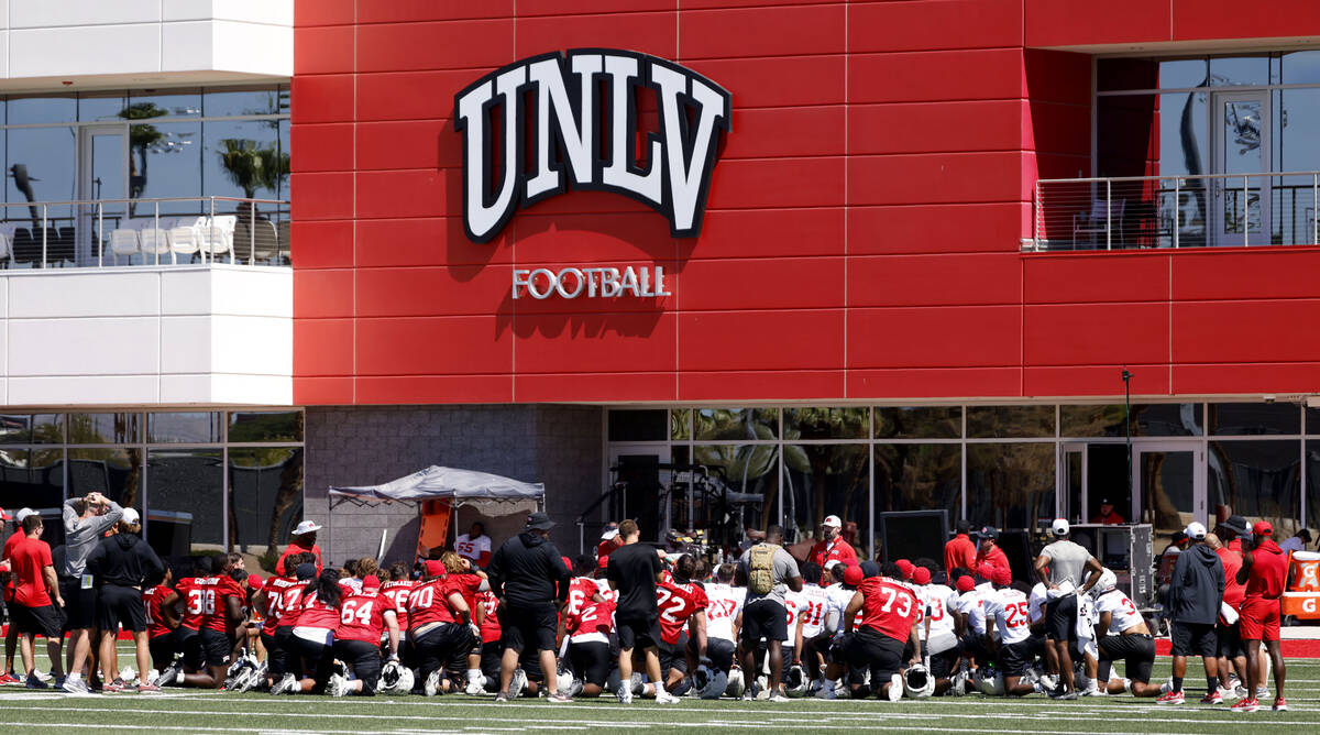 UNLV football head coach Dan Mullen talks to his players after the first day of football camp a ...