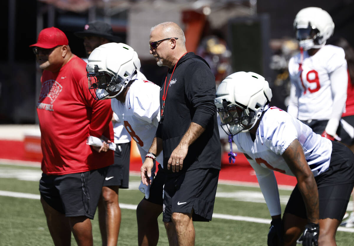 UNLV football defensive line coach Ricky Logo, left, and special teams coordinator Adam Scheier ...