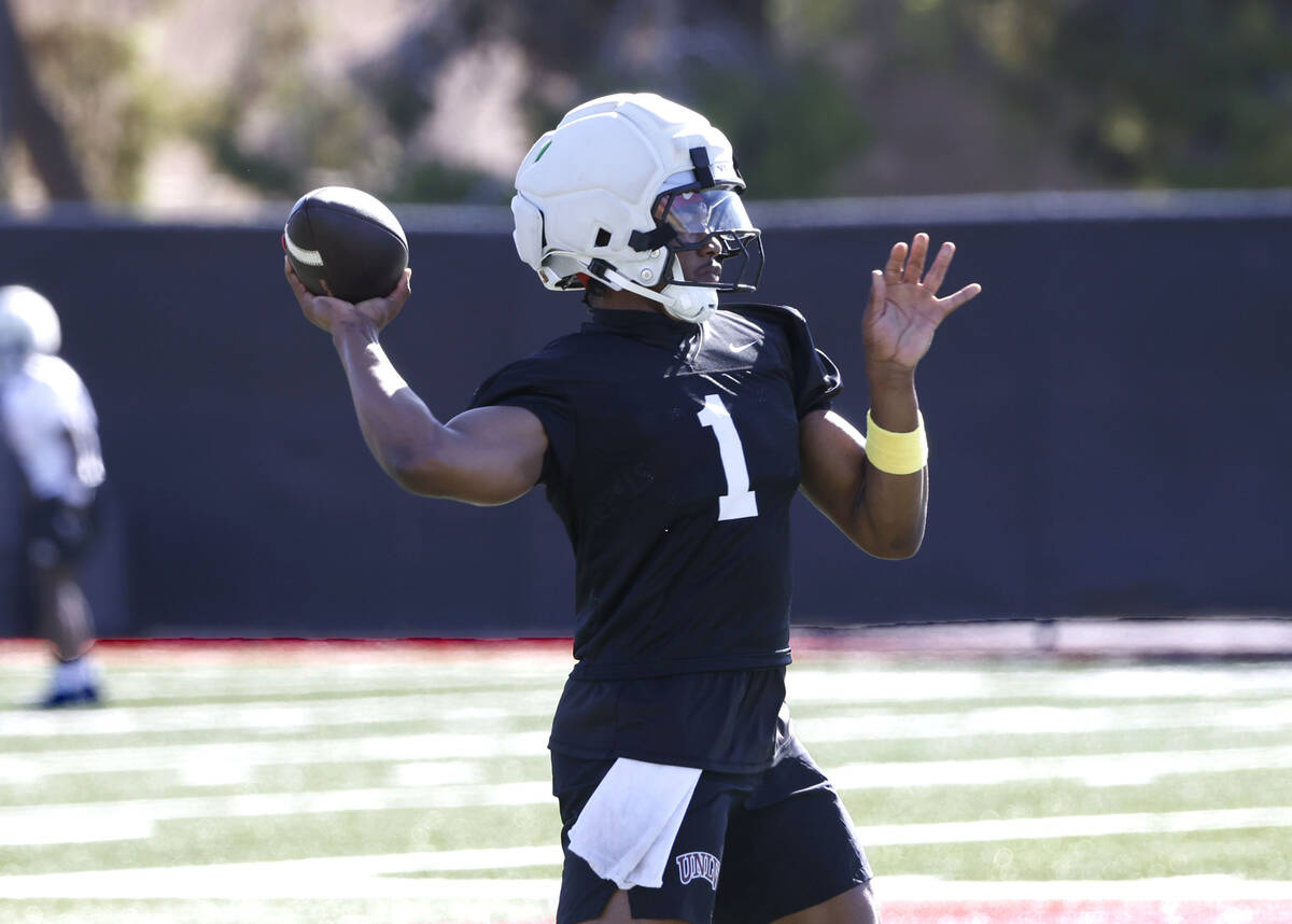 UNLV quarterback Alex Orji (1) throws the ball during the first day of football camp at the Fer ...