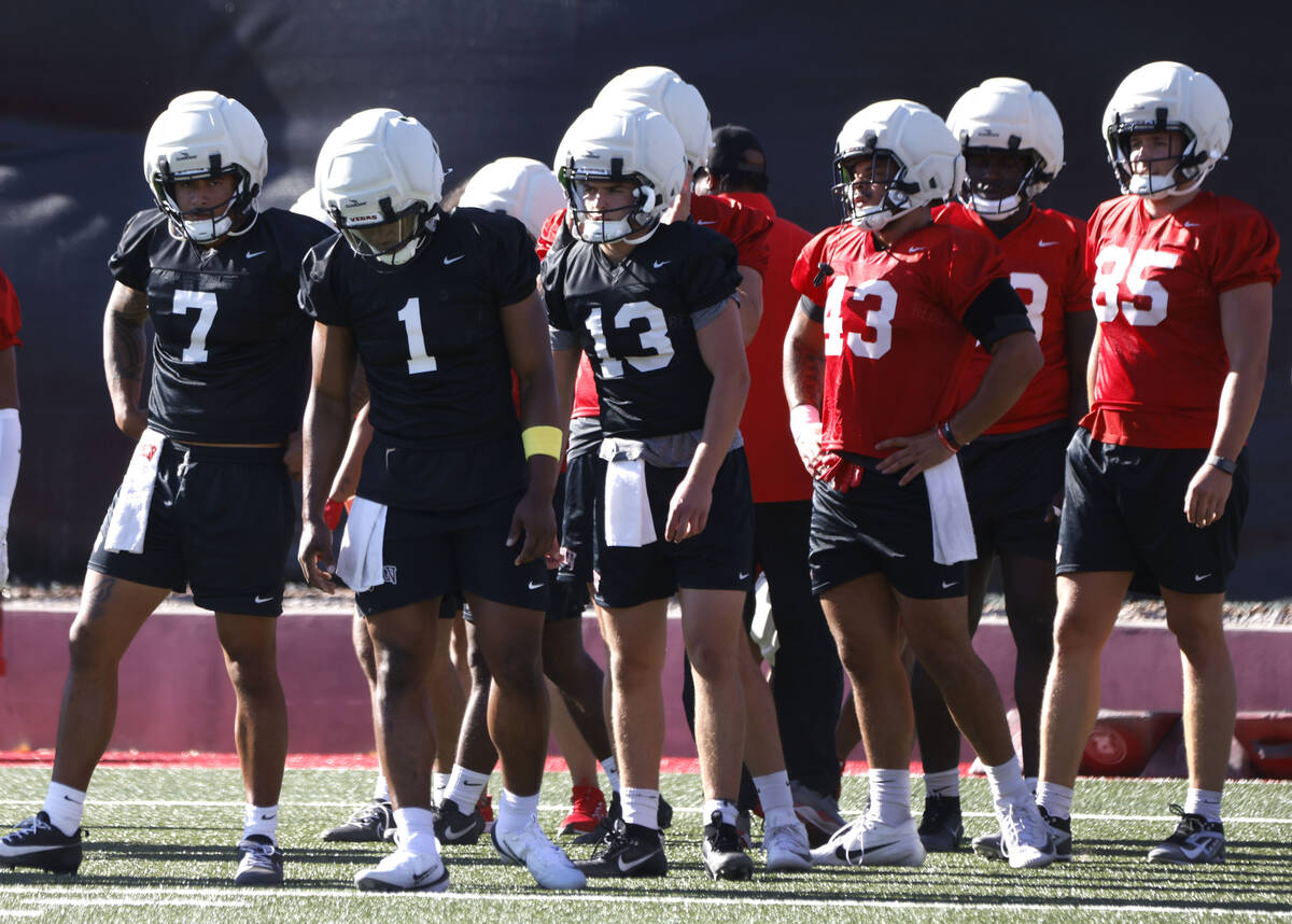UNLV players, including quarterbacks Cameron Friel (7) Alex Orji (1) and Sebastian Circo (13) p ...