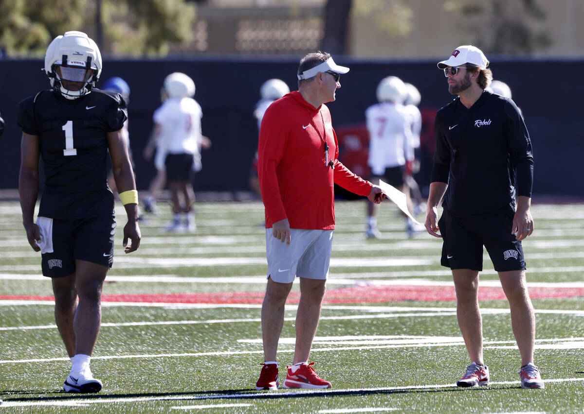UNLV quarterback Alex Orji (1) walks past head coach Dan Mullen, center, and offensive coordina ...