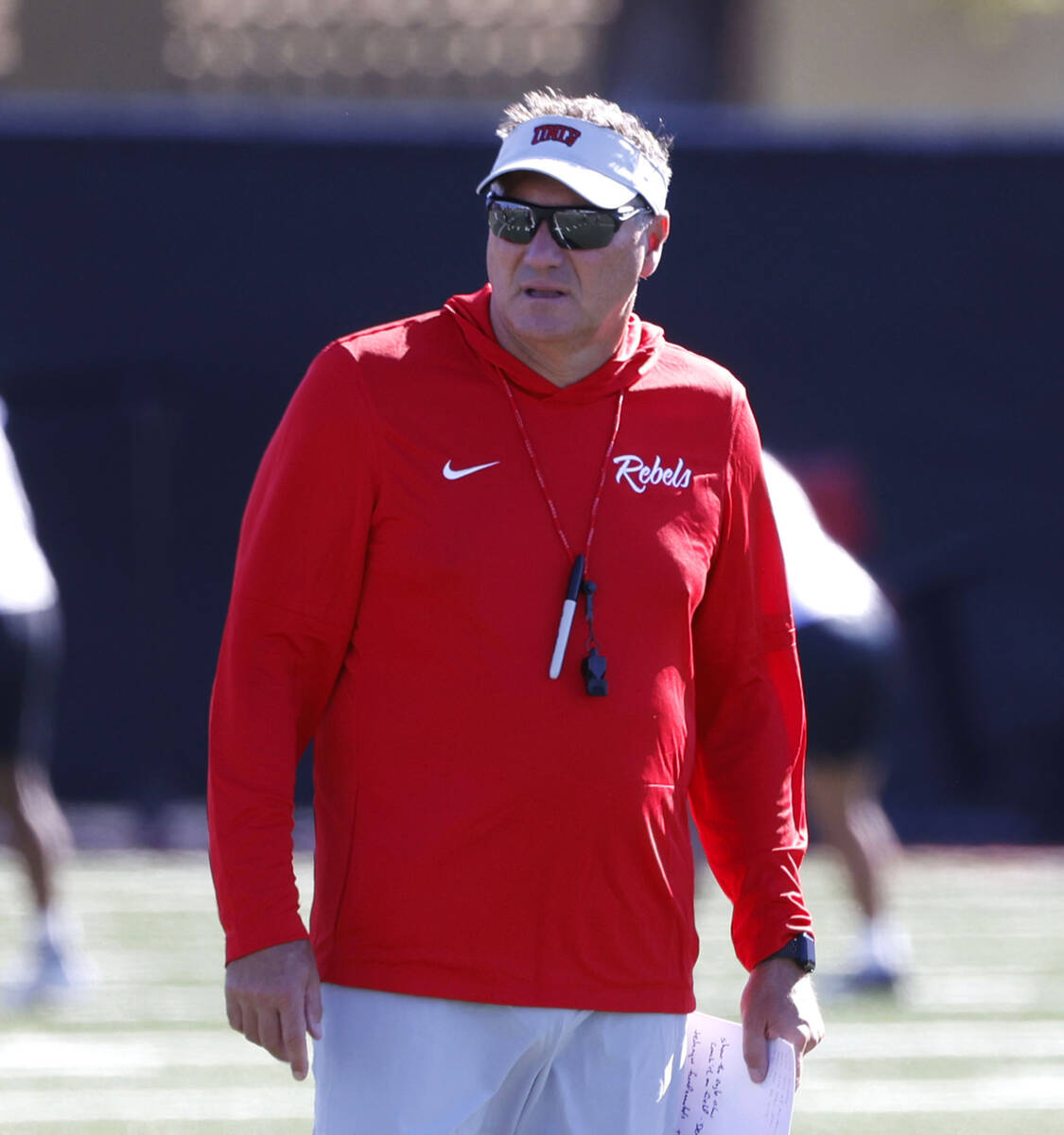 UNLV head coach Dan Mullen watches his players during the first day of football camp at the Fer ...