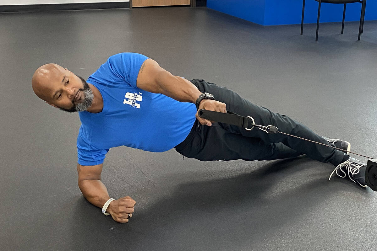 The author performs a cable row from side plank, an example of an exercise that helps strengthe ...