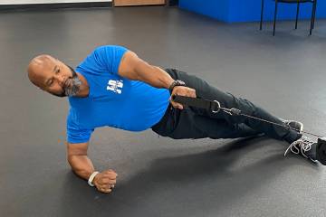 The author performs a cable row from side plank, an example of an exercise that helps strengthe ...